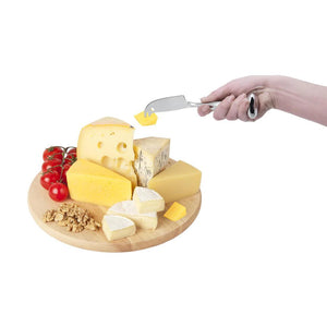 IPAC Standing Cheese Knife in use to pick up a cube of cheese from a cheese tray using the forked tip of the knife.
