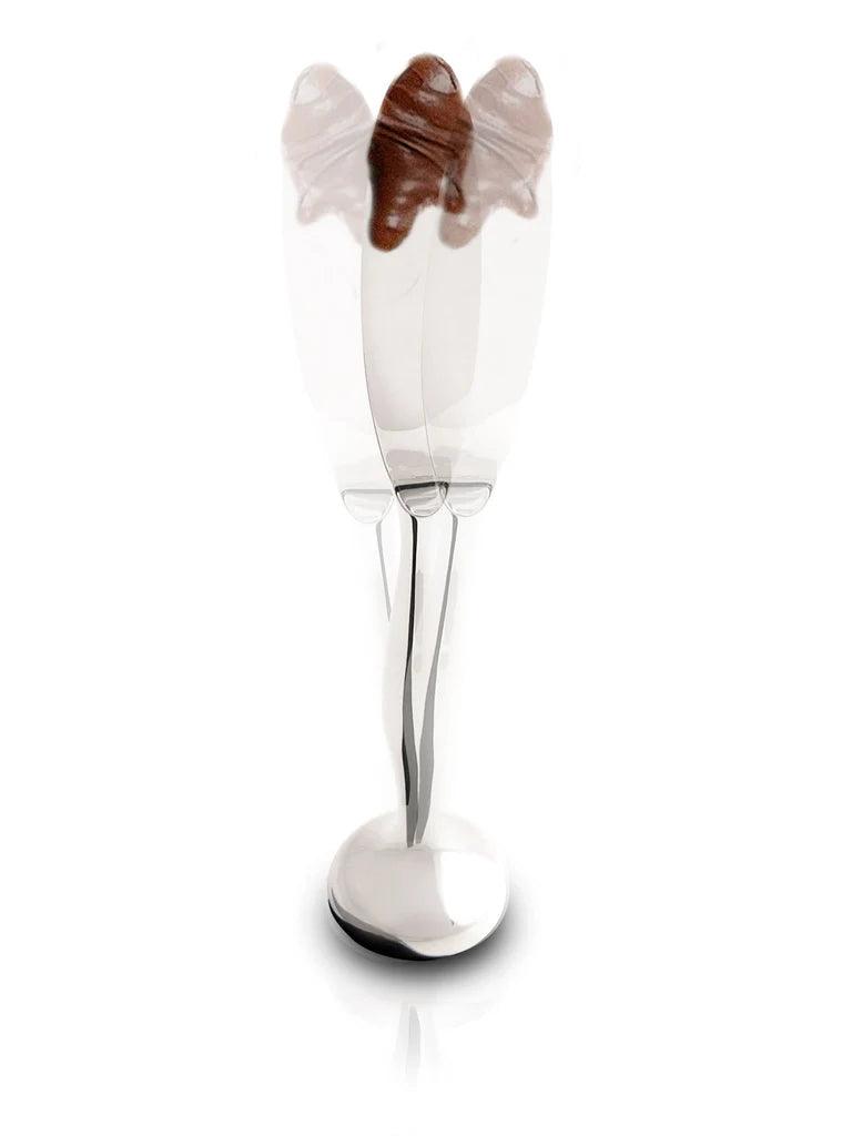 IPAC "Tirso" Standing Spreading knife with a dollop of chocolate spread on the tip.  Ghosted images on either side of the spreader show the range of motion of the spreader when balanced on its base.